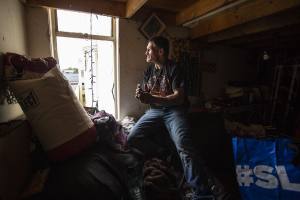 Man looking out window